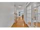 Bright foyer boasts hardwood floors, a staircase, and glass-paneled doors, creating a welcoming entrance at 5033 Homeplace Dr, Apex, NC 27539