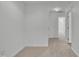 Bright hallway with neutral carpet and white walls leads to various rooms at 5033 Homeplace Dr, Apex, NC 27539