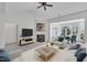 Inviting living room with fireplace and vaulted ceiling leading to a dining area with backyard views at 5033 Homeplace Dr, Apex, NC 27539