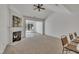 Bright living room features vaulted ceiling, fireplace, and seamless access to an adjacent room at 5033 Homeplace Dr, Apex, NC 27539