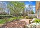 Brick patio with wicker seating, greenery, and landscaping to enhance outdoor living at 5033 Homeplace Dr, Apex, NC 27539