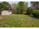 Spacious backyard featuring a storage shed with ample lawn space surrounded by mature trees at 506 N Harrison Ave, Cary, NC 27513