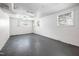 Unfinished basement with concrete block walls and floor, featuring windows for natural light at 506 N Harrison Ave, Cary, NC 27513