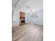 Spacious basement with a brick fireplace and light-colored laminate flooring at 506 N Harrison Ave, Cary, NC 27513