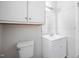Clean, all-white bathroom featuring a sink, mirror, toilet, and ample cabinet space for storage at 506 N Harrison Ave, Cary, NC 27513