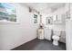 Simple basement bathroom with a toilet, sink, and water heater at 506 N Harrison Ave, Cary, NC 27513
