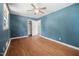 Spacious bedroom with hardwood floors, ample natural light, and a ceiling fan at 506 N Harrison Ave, Cary, NC 27513