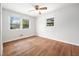Bedroom featuring two windows providing natural light and hardwood floors at 506 N Harrison Ave, Cary, NC 27513