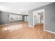 An open living room showcases light wood flooring, gray walls, and seamless access to the kitchen at 506 N Harrison Ave, Cary, NC 27513