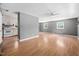 View of the living room with light wood flooring, gray walls, and an open layout with the kitchen at 506 N Harrison Ave, Cary, NC 27513