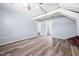 Spacious living room with light blue walls and wood-look flooring and glimpses into a bright adjacent space at 506 N Harrison Ave, Cary, NC 27513