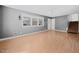 Spacious living area filled with natural light, light wood flooring, and view of the staircase at 506 N Harrison Ave, Cary, NC 27513