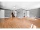 Spacious living room with light wood flooring, gray walls, and a staircase at 506 N Harrison Ave, Cary, NC 27513
