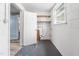 Utility room with windows, storage shelves, and access to the main living area at 506 N Harrison Ave, Cary, NC 27513