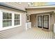 A back porch with wood floors and french doors leading inside the residence at 516 Edinburgh Dr, Burlington, NC 27215