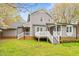 A backyard with a deck and stairs leading to a large yard at 516 Edinburgh Dr, Burlington, NC 27215