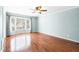 Large bedroom with hardwood floors, a ceiling fan, a bay window, and light blue paint at 516 Edinburgh Dr, Burlington, NC 27215