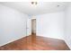 Bright bedroom featuring hardwood floors, neutral paint, and an open doorway at 516 Edinburgh Dr, Burlington, NC 27215