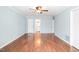 Spacious bedroom with hardwood floors and fresh paint with view into the bathroom at 516 Edinburgh Dr, Burlington, NC 27215