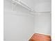 Walk-in closet with wood flooring and white shelving at 516 Edinburgh Dr, Burlington, NC 27215