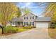 Charming two-story home with gray siding, black shutters, attached garage and landscaped front yard at 516 Edinburgh Dr, Burlington, NC 27215