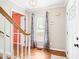 Inviting foyer boasts hardwood flooring and a staircase leading to the upper level of the home at 516 Edinburgh Dr, Burlington, NC 27215