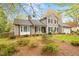 Charming home with a well-maintained lawn, mature trees, and a cozy front porch at 516 Edinburgh Dr, Burlington, NC 27215