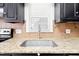 A kitchen featuring granite countertops, stainless steel sink, and black cabinets at 516 Edinburgh Dr, Burlington, NC 27215