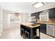 Bright eat-in kitchen with pendant lighting, a center island, and stainless steel appliances in a well-lit space at 516 Edinburgh Dr, Burlington, NC 27215