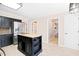 Well-lit kitchen featuring an island with a wood top and black cabinets, plus modern stainless steel appliances at 516 Edinburgh Dr, Burlington, NC 27215
