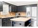 Kitchen with stainless steel refrigerator, granite countertops, and custom island with wood countertop at 516 Edinburgh Dr, Burlington, NC 27215