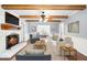 Cozy living room with white brick fireplace, wood beams, and comfortable seating at 516 Edinburgh Dr, Burlington, NC 27215