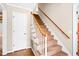 Carpeted staircase with wooden handrail and white balusters leading to the upper level of the home at 516 Edinburgh Dr, Burlington, NC 27215
