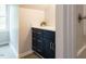 Bathroom with new vanity, white countertop, dark cabinets with brass knobs, and a shower stall at 5209 Rivington Rd, Fuquay Varina, NC 27526