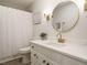 Stylish bathroom with white cabinets, modern fixtures, and round mirror at 5209 Rivington Rd, Fuquay Varina, NC 27526