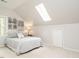 Attic bedroom features a neutral color scheme, art prints, and a skylight at 5209 Rivington Rd, Fuquay Varina, NC 27526