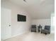Attic room features mounted television, two chairs, and lots of space to lounge at 5209 Rivington Rd, Fuquay Varina, NC 27526
