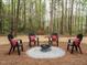 Outdoor firepit area featuring Adirondack chairs on a pea gravel base at 5209 Rivington Rd, Fuquay Varina, NC 27526
