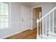 Bright foyer featuring hardwood floors, staircase, white trim, and a view into the rest of the home at 5209 Rivington Rd, Fuquay Varina, NC 27526