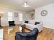 Inviting living room featuring a comfortable sofa, hardwood floors, ceiling fan, and neutral tones for relaxation at 5209 Rivington Rd, Fuquay Varina, NC 27526