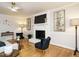 Stylish living room with fireplace, hardwood floors, ceiling fan, and neutral decor for a cozy atmosphere at 5209 Rivington Rd, Fuquay Varina, NC 27526