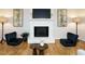 Comfortable living room featuring a brick fireplace, hardwood floors, and elegant decor for a welcoming space at 5209 Rivington Rd, Fuquay Varina, NC 27526