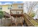 Two-story backyard deck and wooden fence with a private entrance beneath the deck stairs at 5551 Vista View Ct, Raleigh, NC 27612