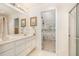 Bright bathroom with shower, double sinks, and door to bedroom at 5551 Vista View Ct, Raleigh, NC 27612