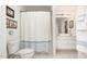Bright bathroom with shower and tub combo, white cabinets, and tiled floors at 5551 Vista View Ct, Raleigh, NC 27612