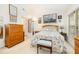 Bright bedroom with floral bedding, wood furniture, and carpeted floors at 5551 Vista View Ct, Raleigh, NC 27612