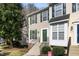 Inviting two-story townhome with beige siding, complemented by green shutters, and a well-maintained front yard at 5551 Vista View Ct, Raleigh, NC 27612