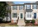 Charming two-story townhome featuring beige siding, green shutters, and a welcoming front entrance with a green door at 5551 Vista View Ct, Raleigh, NC 27612