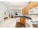 Functional kitchen with wood cabinets, ample counter space, and an open view to the adjacent living area at 5551 Vista View Ct, Raleigh, NC 27612