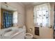 Bathroom with a single sink vanity, standard toilet, and shower/tub combo at 5578 Tabbs Creek Church Rd, Oxford, NC 27565